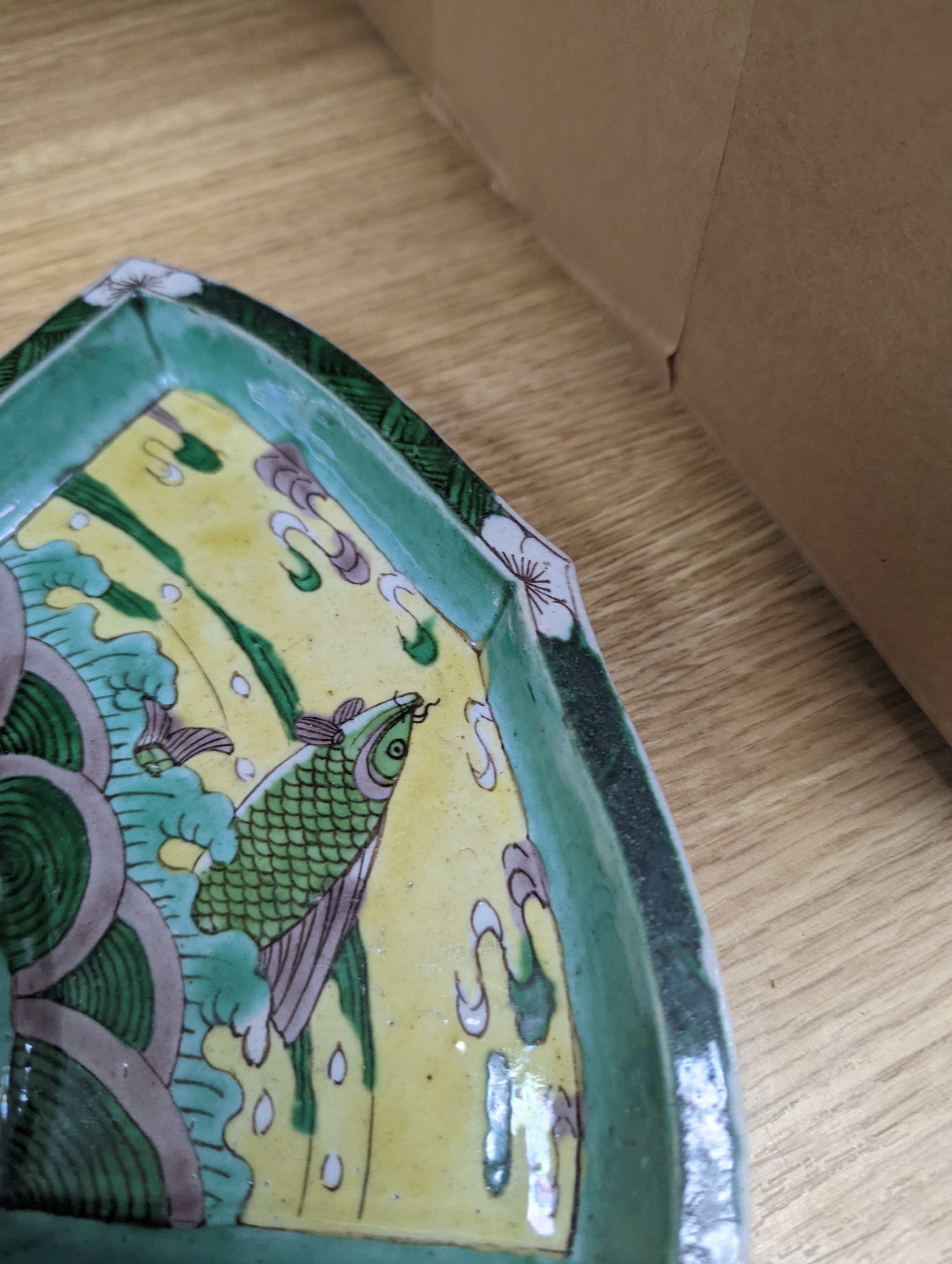 A pair of Chinese famille verte biscuit fan-shaped sweetmeat dishes, Kangxi, 20 cms wide.